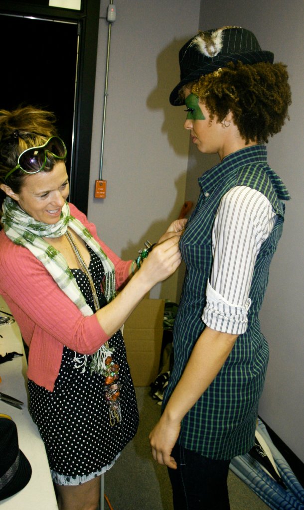 Fashion designer Meredith Alex fits model Maureen Emerson's shirtdress before the show began.