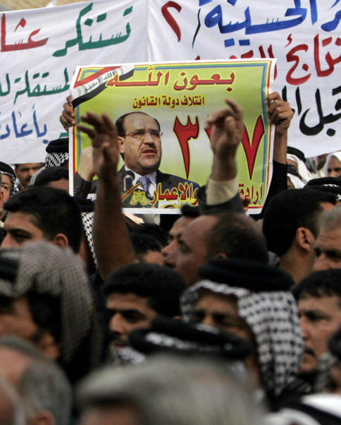 Supporters of Iraqi Prime Minister Nouri al-Maliki, seen in the poster, chant anti-Baathist slogans Wednesday during a protest in Karbala, Iraq. Hundreds of residents rallied to demand a manual recount of votes in the March 7 elections.