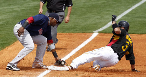 Akinori Iwamura of the Pittsburgh Pirates slides safely into third base with a first-inning steal Wednesday, beating a tag by Jorge Jimenez of the Boston Red Sox. Boston won, 6-4.