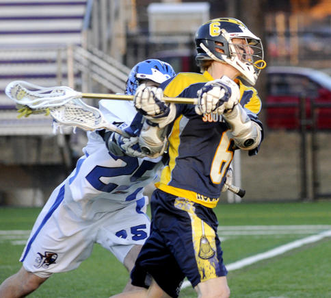 Dan Thomas of the University of Southern Maine snaps off a shot in front of Stephen Lucafo of St. Joseph’s Wednesday night at Deering High. USM raced to an 18-5 win.