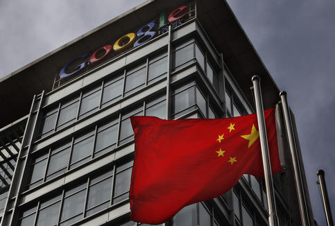 A Chinese flag waves below the Google logo outside the Google China headquarters in Beijing on Thursday. Google’s decision to move its Chinese search engine offshore wins praise in the United States, but threatens to turn the company into a pariah in China.
