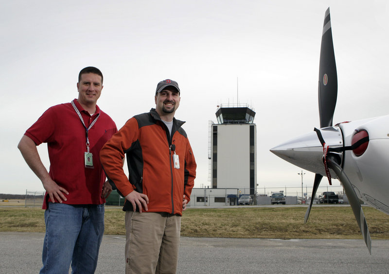 Kevin Plante, left, and Chris Presley, both air traffic controllers, ended up using a road map to guide an inexperienced pilot into the Portland International Jetport.