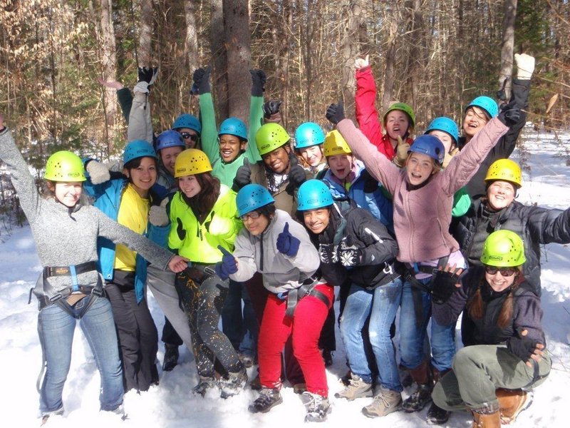 The pioneer class of Coastal Studies for Girls celebrates after their Ropes Course challenge.