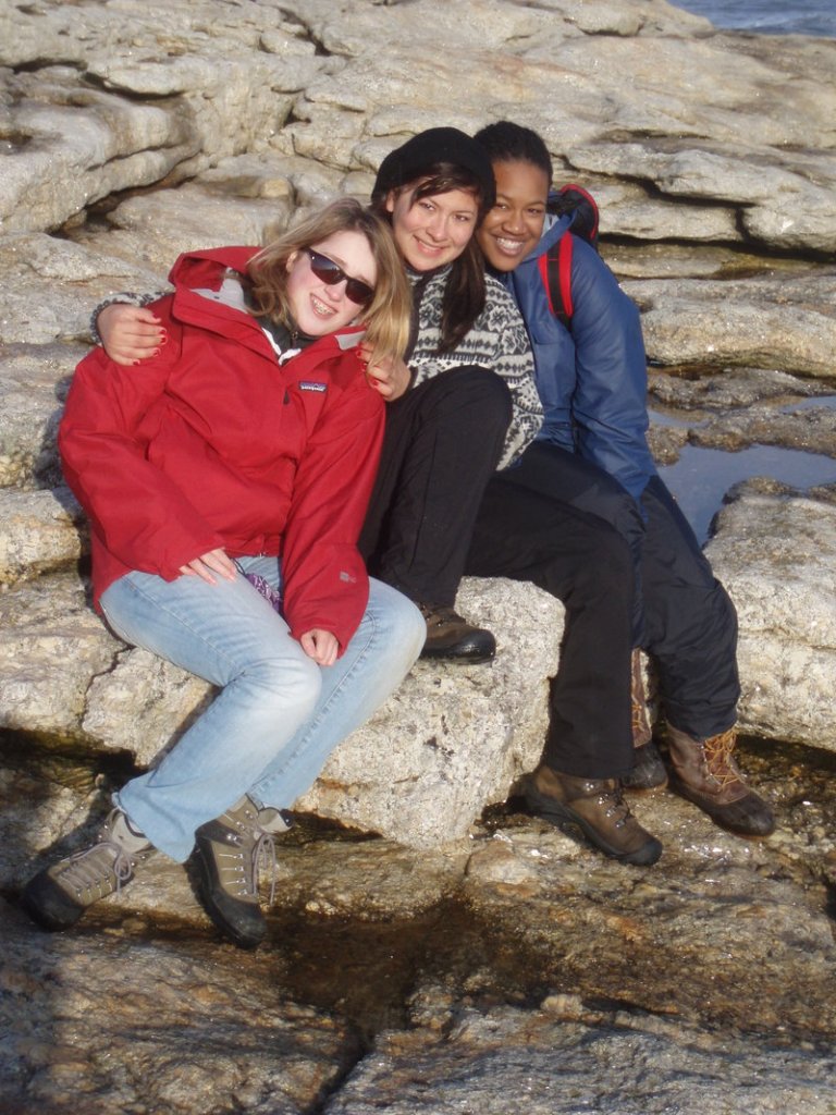 Margaret Keefe of Camden, Christine Munoz, Ingelwood, Calif., and Frankline Mardi of Boston share a bonding moment at Popham Beach after studying beach erosion.
