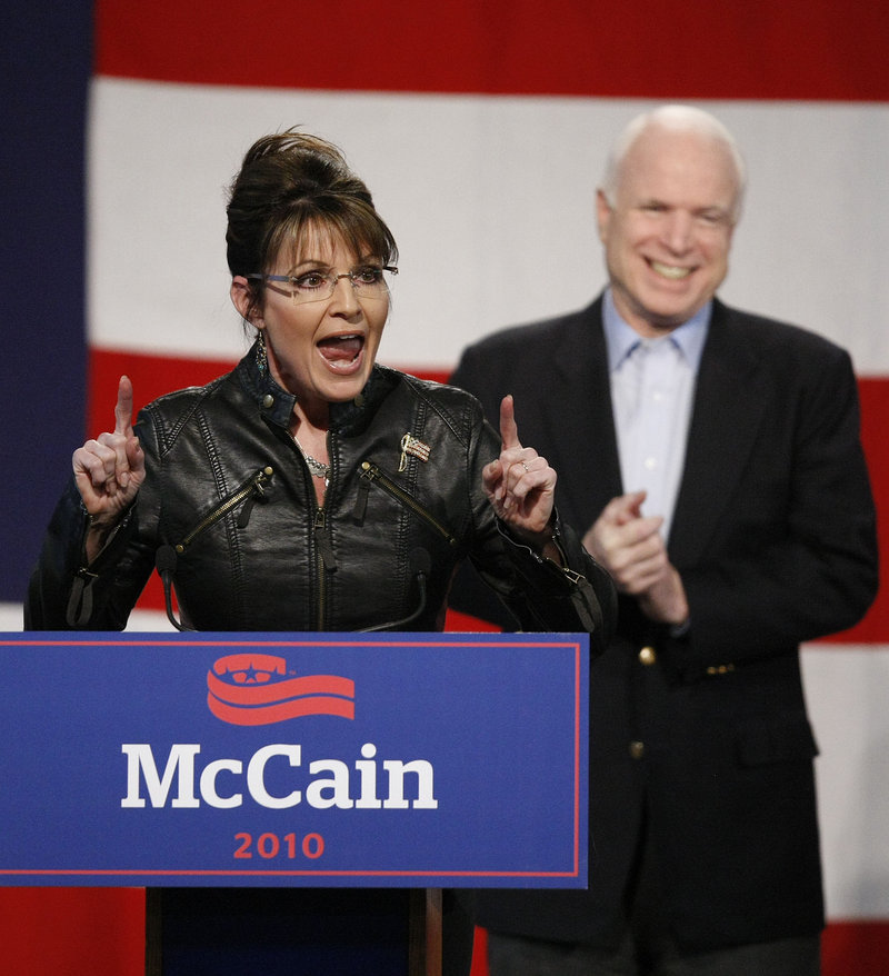 The Associated Press Sen. John McCain applauds former running mate Sarah Palin as she makes a point Friday at a campaign rally in Tucson, Ariz.