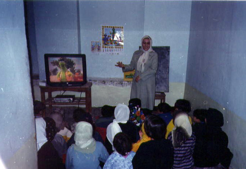 Afghan children watch “Koche Sesame,” an adaptation of “Sesame Street.” Some educators and TV producers in Afghanistan hope that the show will one day teach youngsters across the nation a gentler way of thinking.