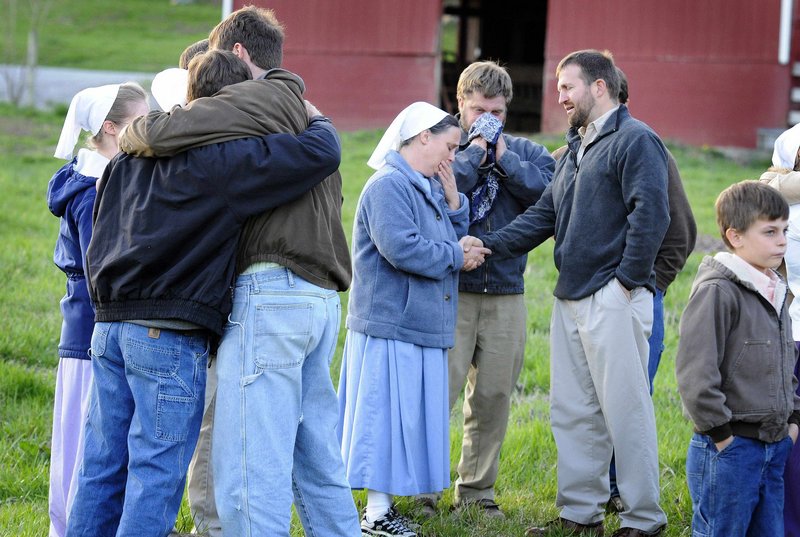 Friends and family grieve outside the home of John and Sadie Esh in Marrowbone, Ky. Eight members of the Esh family and two friends were killed Friday when a tractor-trailer crossed a median and collided head-on with their van.