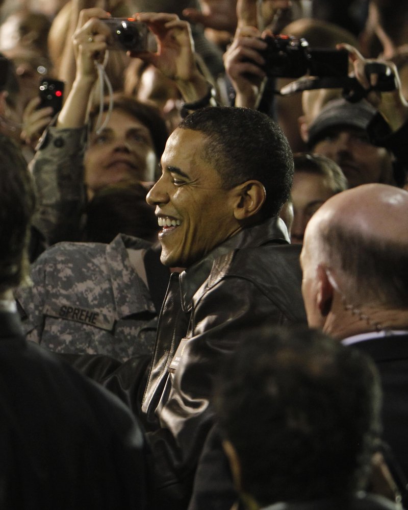 President Obama is swarmed by U.S. troops at Bagram Air Base in Afghanistan on Sunday during a surprise visit. “Your services are absolutely necessary ... to America’s safety,” he told the troops.