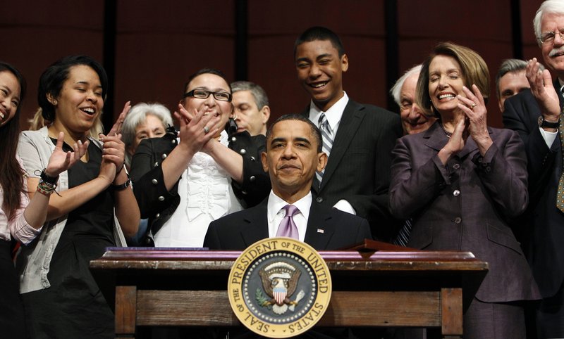 President Obama reacts Tuesday after signing the Health Care and Education Reconciliation Act of 2010 with Speaker Nancy Pelosi, D-Calif, right, students and others at Northern Virginia Community College in Alexandria. The bill shifts responsibility for student loans from banks to government.
