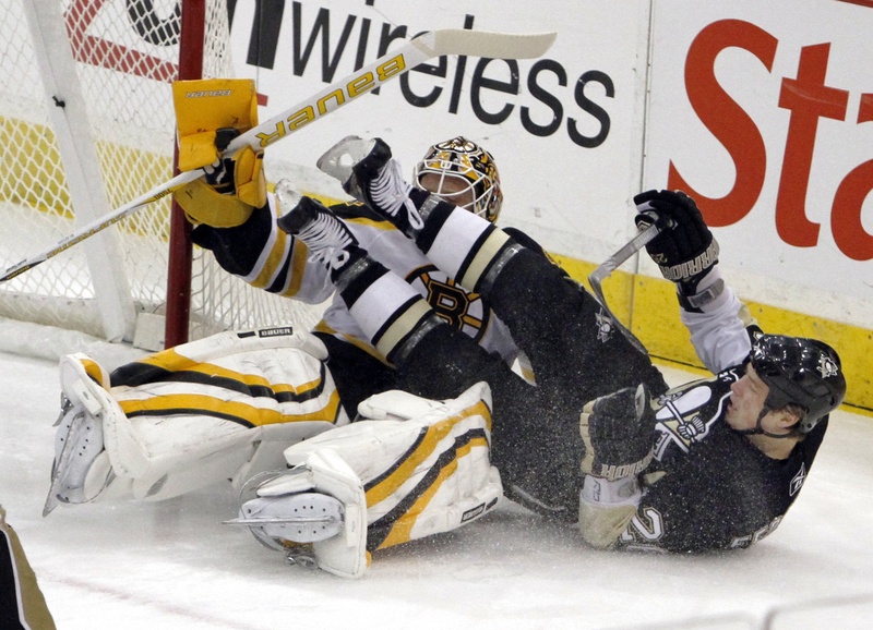 Ruslan Fedotenko of the Penguins crashes into Bruins goalie Tim Thomas during Sunday’s game in Pittsburgh. The Penguins improved to 4-0 since the Olympic break, beating Boston 2-1.