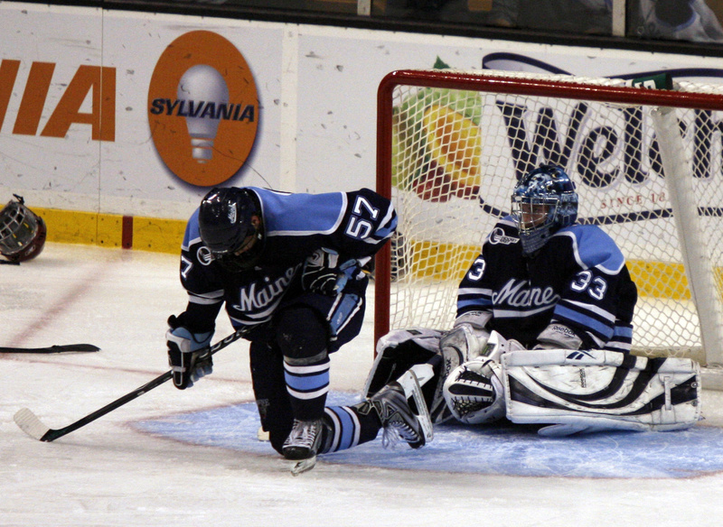 Matt Mangene and goalie Dave Wilson of the University of Maine absorb what just happened Saturday night immediately after Boston College scored the overtime goal that won the Hockey East title and brought the Black Bears’ season to an end.