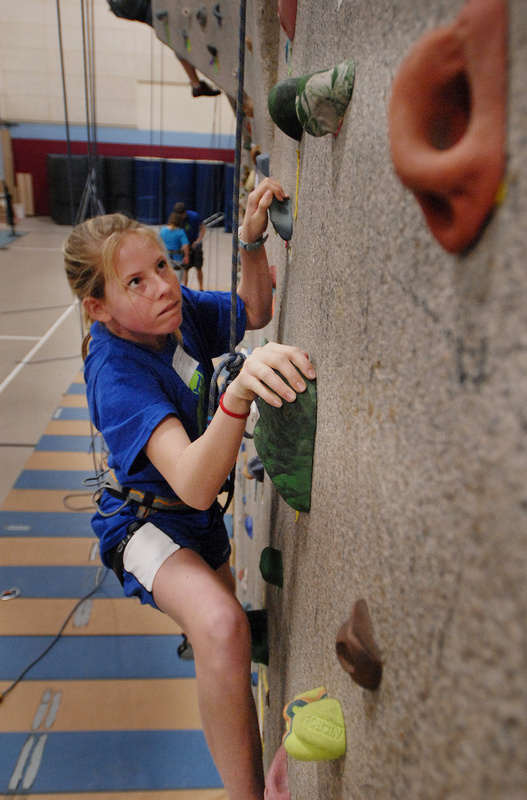 Marijke Rowse of Falmouth Middle School climbs the rock wall at Windham High School during the Teens to Trails Conference on April 4. Students came to learn fly-fishing, how to cook a campfire meal, how to start a fire and more in 70 seminars.