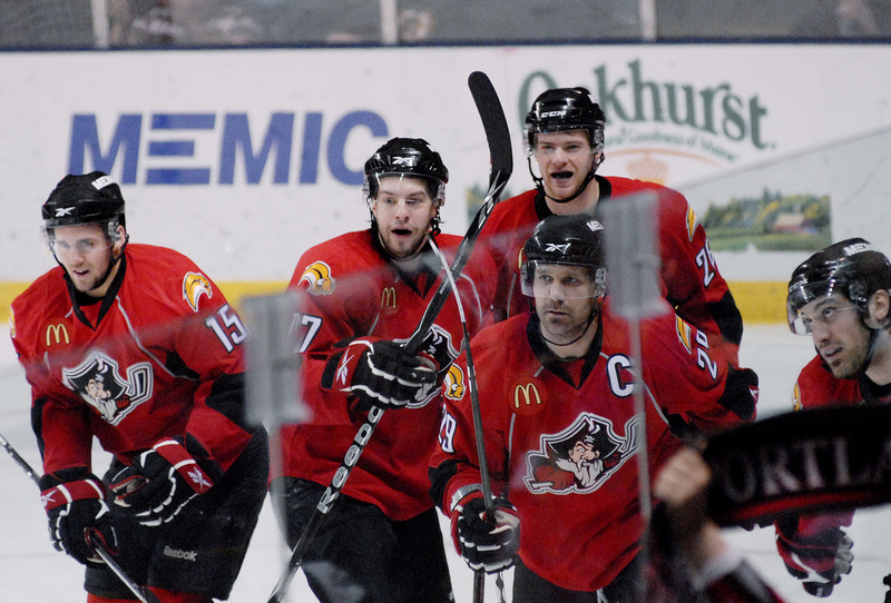 Felix Schutz, left, Marc-Andre Gragnani, Mike Kostka, back, Brad Larsen, front, and Mark Mancari celebrate Mancari’s go-ahead goal in the first period Sunday against the Worcester Sharks. The Pirates won, 5-2.