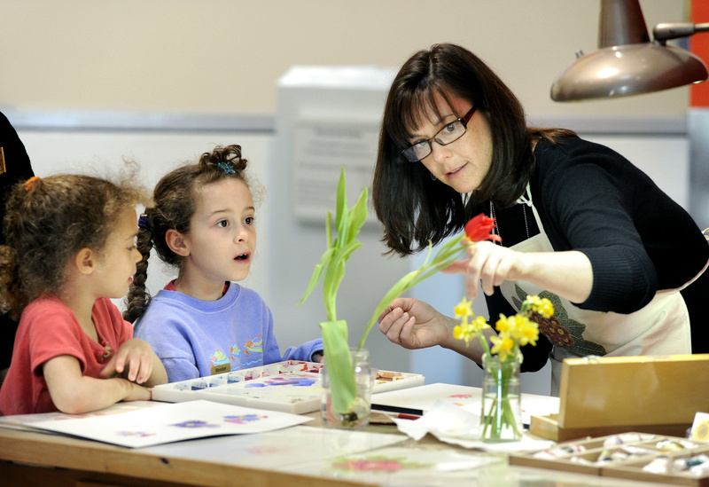 Focusing the young artists’ attention on botanical still lifes, Yarmouth artist Kerry Charles works with 5-year-old Nina Chase and her sister Maya, 8, of Scarborough.