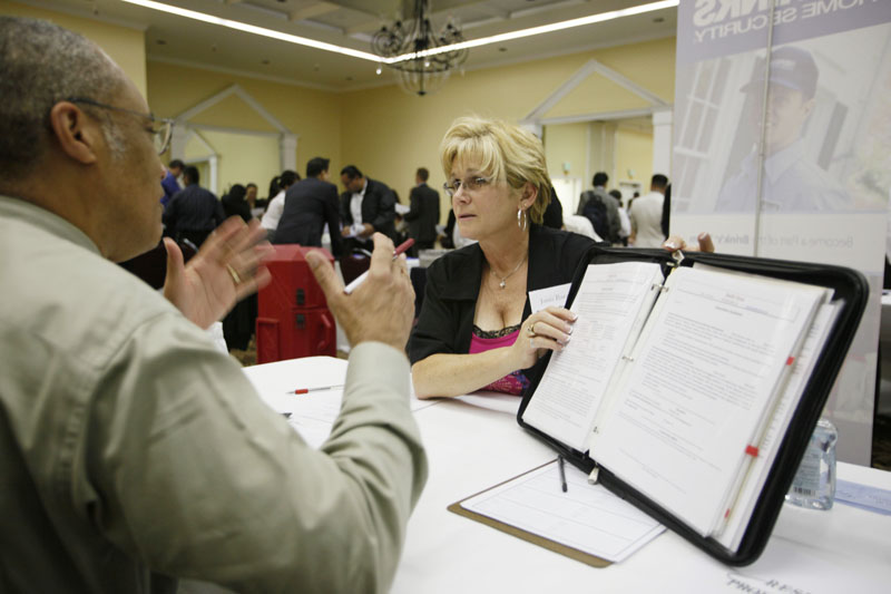 Stafford Muller, left, of Fremont, Calif., gets help with his resume recently from Janis Barat, right, of Resume Professionals at a career fair put on by National CareerFairs in San Jose, Calif. The nation's economy created the largest number of jobs last month since the recession began, while the unemployment rate remained at 9.7 percent for the third straight month.