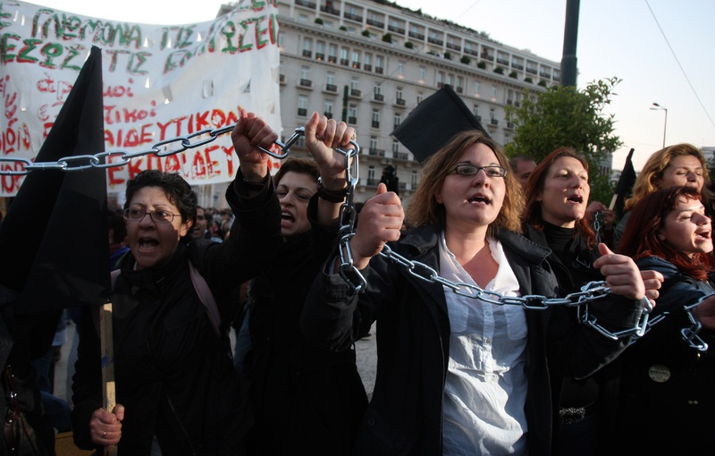 Unemployed schoolteachers chant slogans at an anti-government demonstration by civil servants Tuesday outside the Greek Parliament in Athens. The country’s debt crisis has led to austerity measures, including thousands of job cuts.