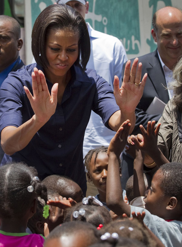 Michelle Obama greets children at a school in Port-au-Prince today.