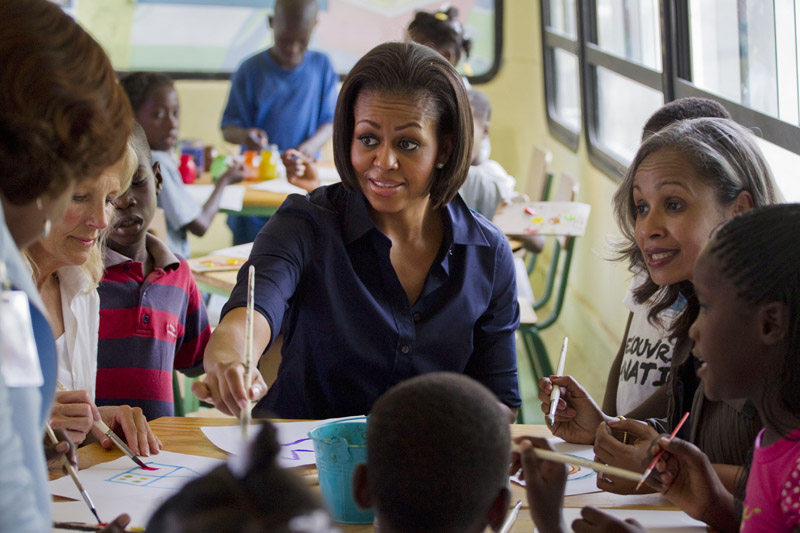 First lady Michelle Obama, Haiti's first lady Elisabeth Debrosse, right, and Vice President Joseph Biden's wife, Jill Biden, paint with children in a school in Port-au-Prince today during a surprise visit to the devastated Haitian capital.