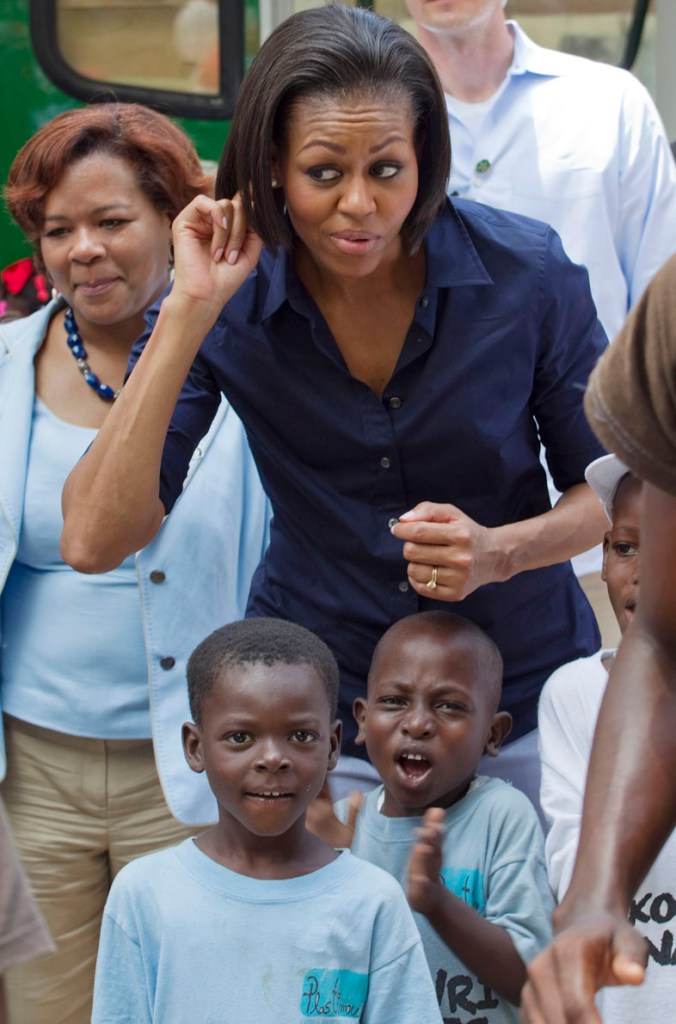 Michelle Obama gestures as she meets children in Port-au-Prince.