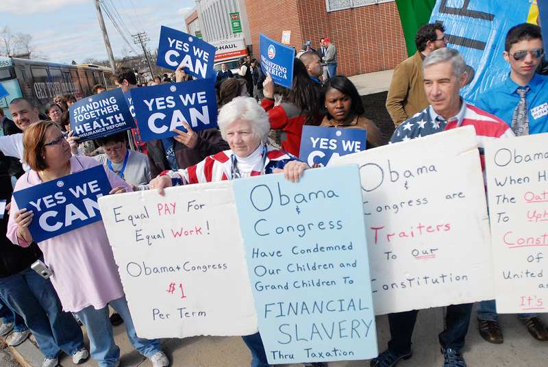 Anti-Obama protesters Pat and Frank Giordano of Newport stand in front of Obama supporters outside the Expo today.