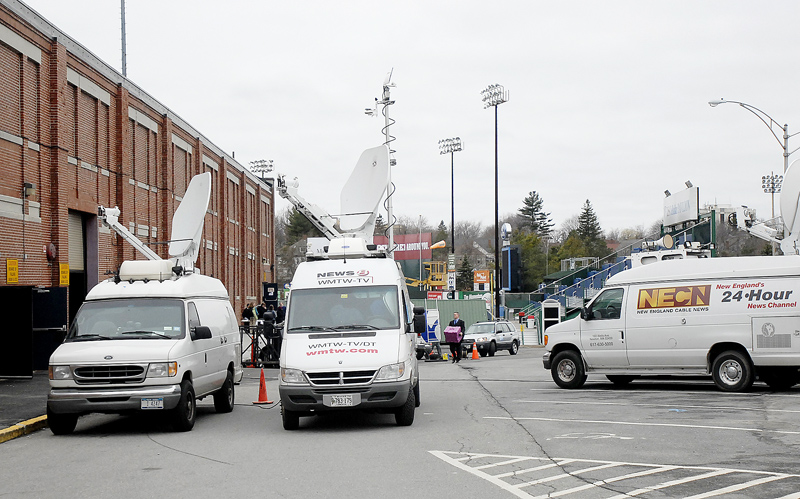 Vans carrying equipment for media outlets take position at the Portland Expo today in advance of President Obama's scheduled appearance.