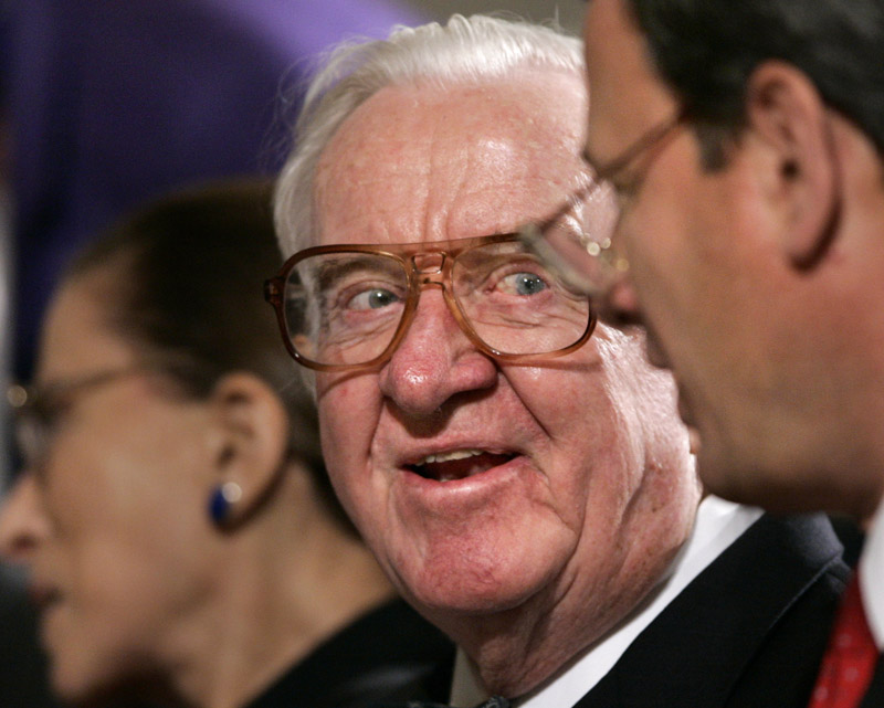Associate Justice John Paul Stevens, center, smiles as he chats with Chief Justice John G. Roberts, right, in this 2006 file photo. Stevens, the court's oldest member and leader of its liberal bloc, is retiring.