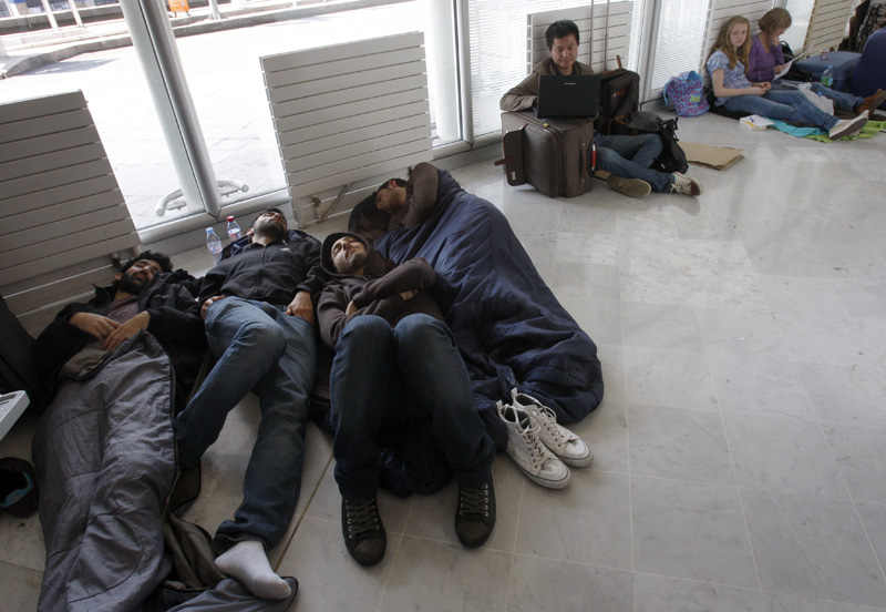 Stranded passengers camp out today at Roissy Charles de Gaulle Airport.