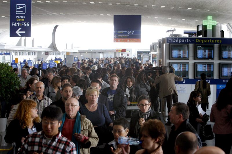 Travelers gather inside a terminal at the Roissy Charles de Gaulle Airport outside Paris on Friday, despite commercial flights being canceled by a plume of volcanic ash originating from Iceland.