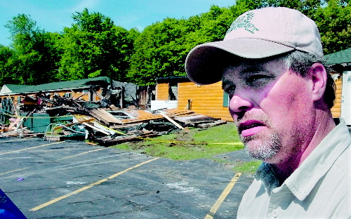 AFTERMATH: Grand View Topless Coffee Shop owner Donald Crabtree outside his business the morning of June 3 after it was destroyed by fire.