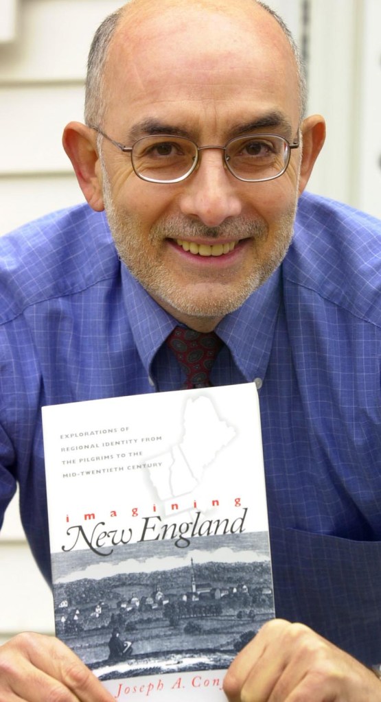 University of Southern Maine history professor Joseph Conforti holds up his book "Imagining New England: Explorations from the Pilgrims to the Mid-Twentieth Century" in 2001.