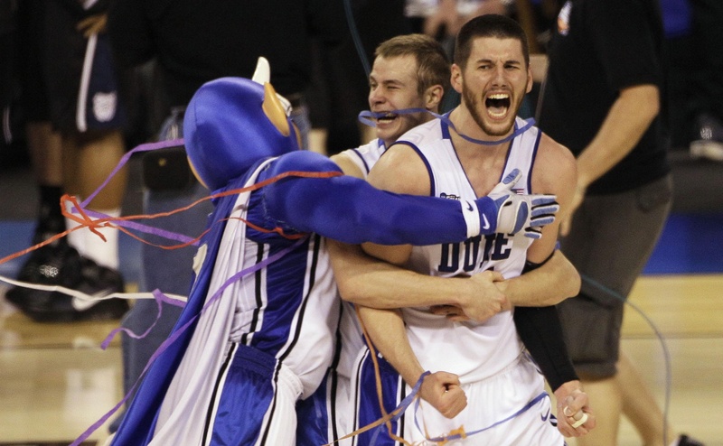 Duke players Brian Zoubek, right, Jon Scheyer, center, and the team mascot celebrate after Duke's 61-59 win over Butler in the men's NCAA Final Four college basketball championship game Monday in Indianapolis.