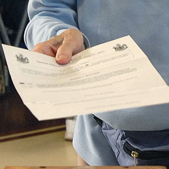 A voter submits a ballot in Saco in 2007.
