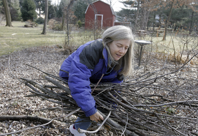 Marie Bertolette Page, 57, gathers sticks in her yard in Willow Grove, Pa. Page, who has a large garden and tends two other private gardens, swears by pilates and exercise class, as well as brisk walks and stretching to keep her muscles toned for gardening. Another important factor: Plan your work. Trying to do too much in a short period of time can lead to injuries.
