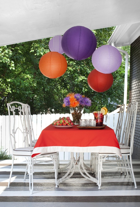 Flynn used porch and floor paint, paper lanterns and flea-market finds for an outdoor dining space.