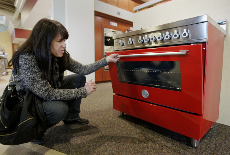 Brenda Knehans checks out a six-burner, 36-inch Bertazzoni range. The commercial-style home appliance retails for $4,699, though a more standard size from the line can be found for around $2,000. 10000000 krtfeatures features krtlifestyle lifestyle krtnational national leisure LIF krtedonly mct 10009000 FEA krthome home house housing LEI 2010 krt2010 kitchen appliance