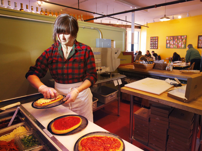 Kate Skinner makes pizzas at Pie in the Sky Pizza, upstairs at the Public Market House on Monument Square in Portland.