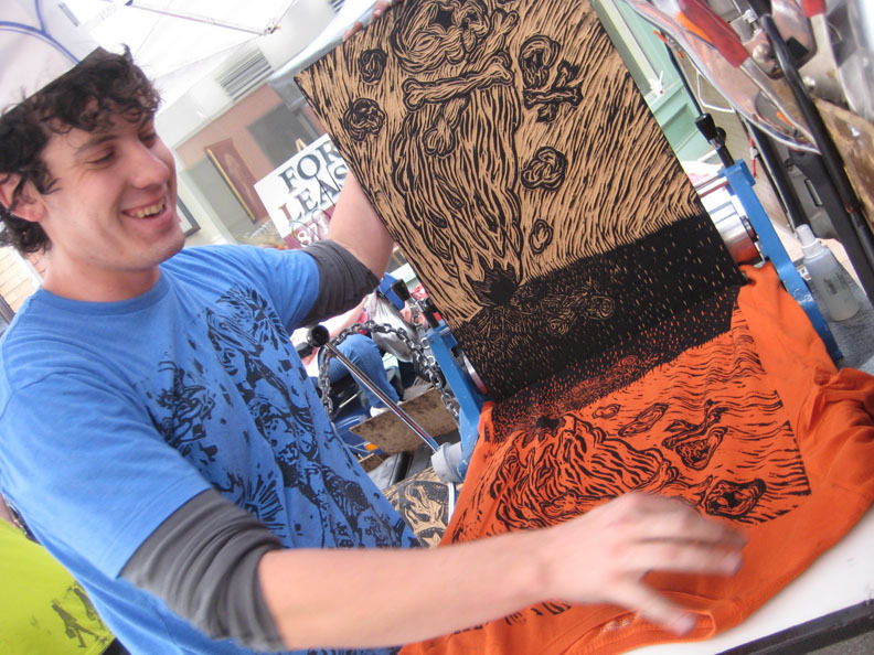 Drive By Press printmaker Greg Nanney creates one-of-a-kind shirts in front of the Maine College of Art.