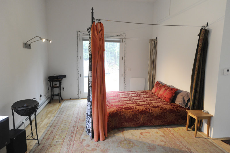 The bedroom, at the far end of the approximately 60-foot-long first floor