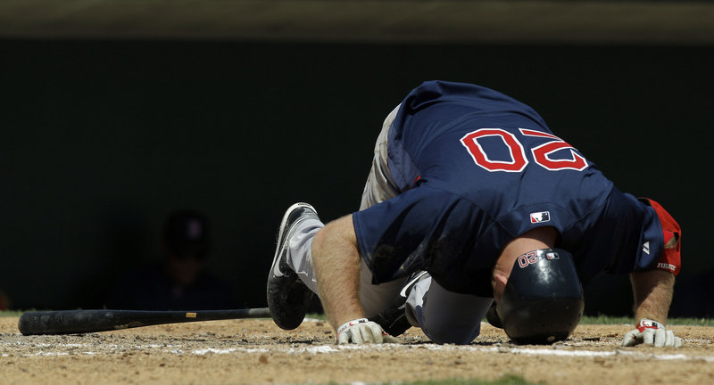 Kevin Youkilis is in pain after fouling a fourth-inning pitch off his foot during Boston’s 14-6 exhibition victory over the Baltimore Orioles on Wednesday.