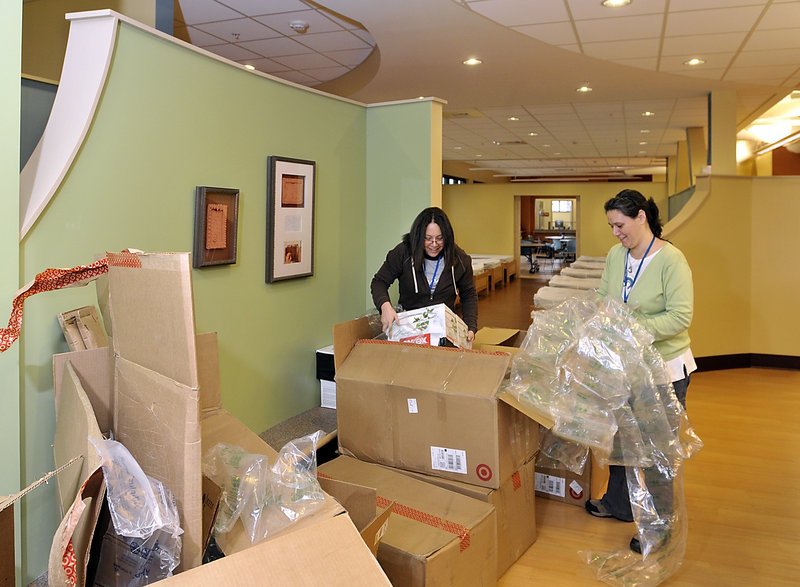 Frances Mercado, left, and Tracy Kane unpack supplies for Florence House on Valley Street, the new home for homeless women.
