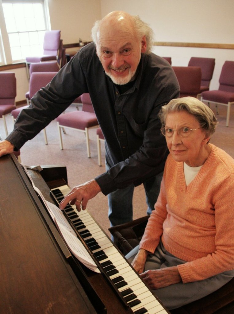 Harry Moon, director of the Community Chorus of South Berwick, and pianist Audrey Adams review a score for the group's concerts this weekend.