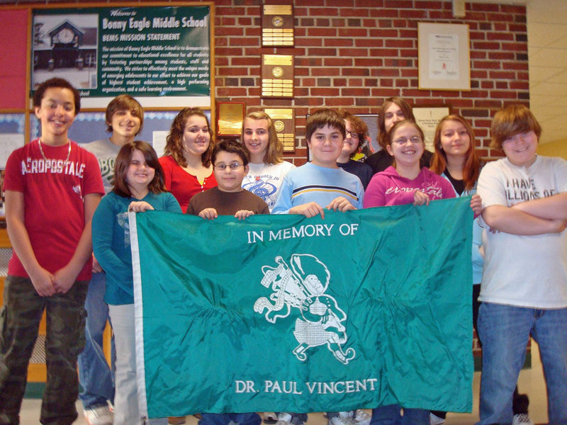 The Bonny Eagle Middle School Civil Rights Team and some Drama Club students have collaborated to write, act and film skits detailing different kinds of bullying and harassment in school. Here, they pose with the schools honor flag, during a ceremony celebrating their work. Pictured are from left, front, Rose Michaelson, Roscoe Deering, Evan Gillingham and Stevie Buck; and rear, Mason White, Waice McKenzie, Sarah Poore, Autumn London, Carter Gleason, Austin Leach, Sabrina Frost and Josh Brown.