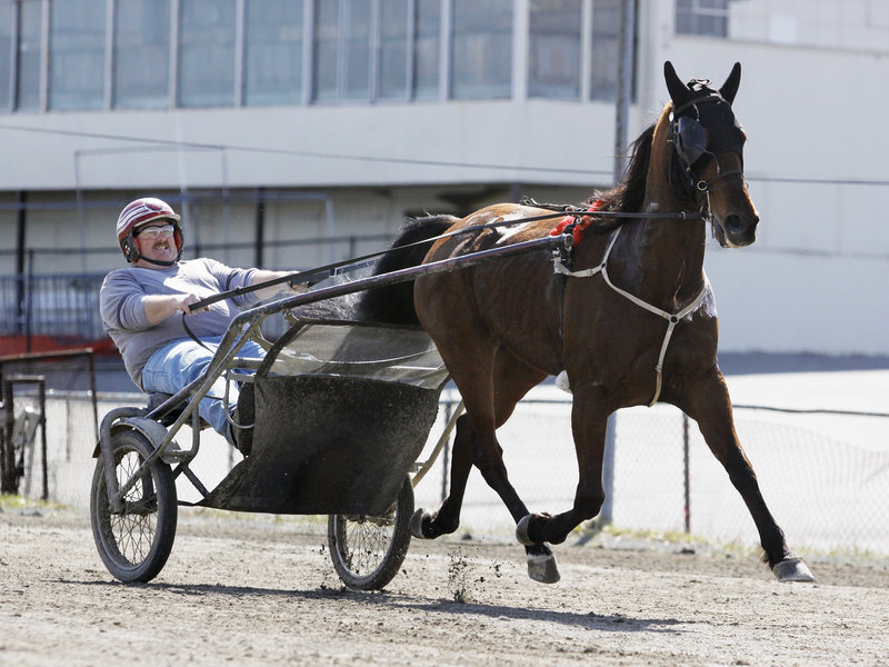 Richard Robertson Jr. of Scarborough jogs with Dua Don Thursday at Scarborough Downs. The track will be celebrating 60 years of harness racing this season.