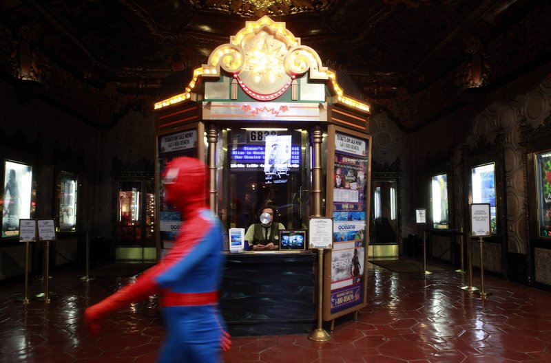 A person dressed as Spider-Man walks past the El Capitan Theatre in Los Angeles. The U.S. Commodity Futures Trading Commission is expected to rule this month on proposals to let speculators bet on a movie's expected box office receipts.