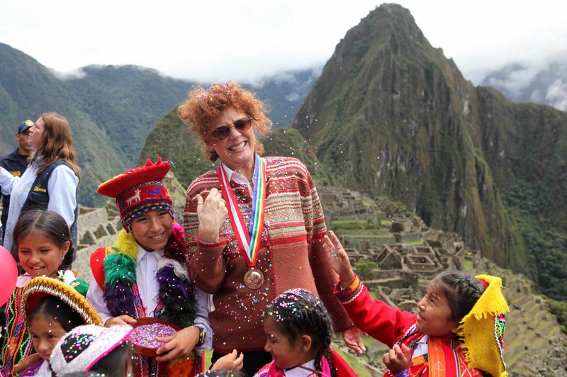 Actress Susan Sarandon reacts Thursday as a a girl tosses confetti during the reopening of the citadel of Machu Picchu. Peruvian officials celebrated the reopening of the Inca citadel after a two-month closure due to flooding.