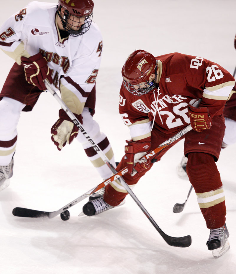 Brian Dumoulin, left, a freshman defenseman from Biddeford, is living his dream this week playing for Boston College in the NCAA men’s hockey Frozen Four.