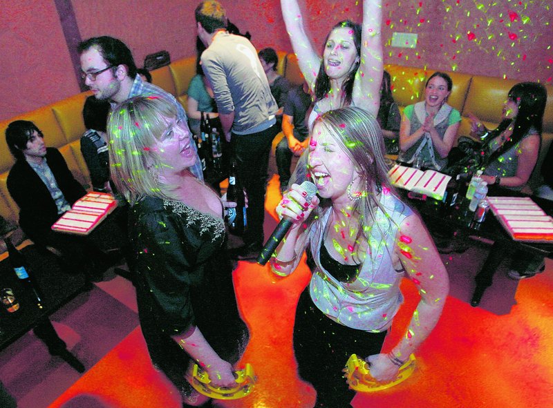 Anne Walls and Samatha Hackett, left, sing karaoke with friends at Walls’ birthday party at Rosen Music Studio, a karaoke/bar/restaurant in Los Angeles, Calif., last month. Sales of karaoke machines have slumped since the karaoke industry peaked in 2002.