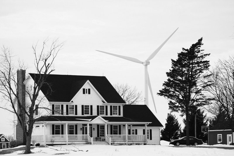 Wind turbines are only required to be at least 1,400 feet from the foundation of nearby homes such as this one in Shabbona, Ill.
