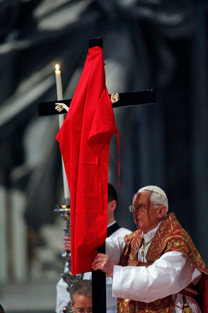 The Associated Press Pope Benedict XVI uncovers a crucifix draped in red during a service in St. Peter’s Basilica at the Vatican on Friday, preparing for Good Friday ceremonies.