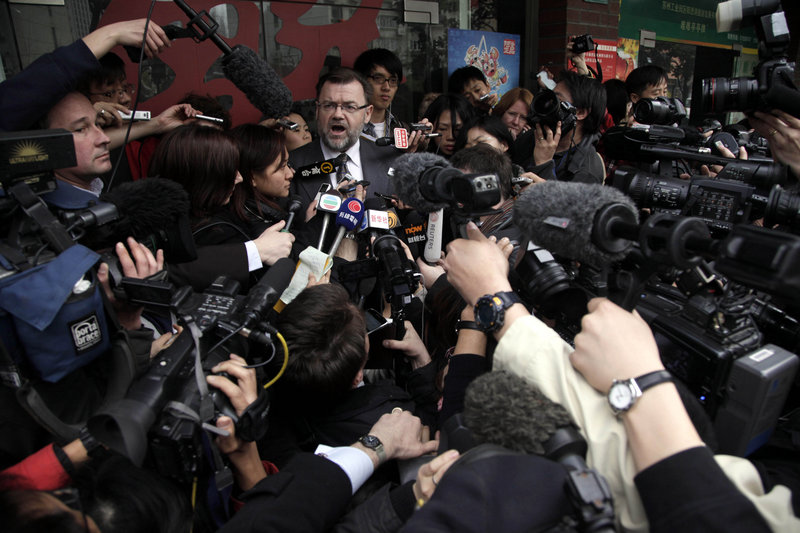 Tom Connor, Australia’s consul-general in Shanghai, China, center, briefs journalists Monday, when four employees of British-Australian mining giant Rio Tinto were convicted of bribery charges and sentenced to prison.